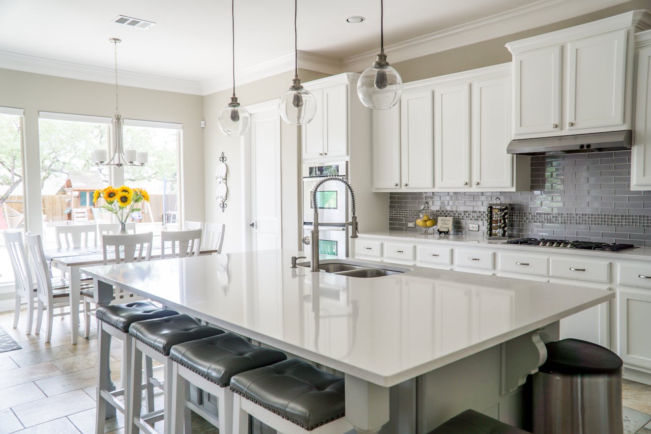 about-02 Spacious modern kitchen with white cabinets and island in natural light.