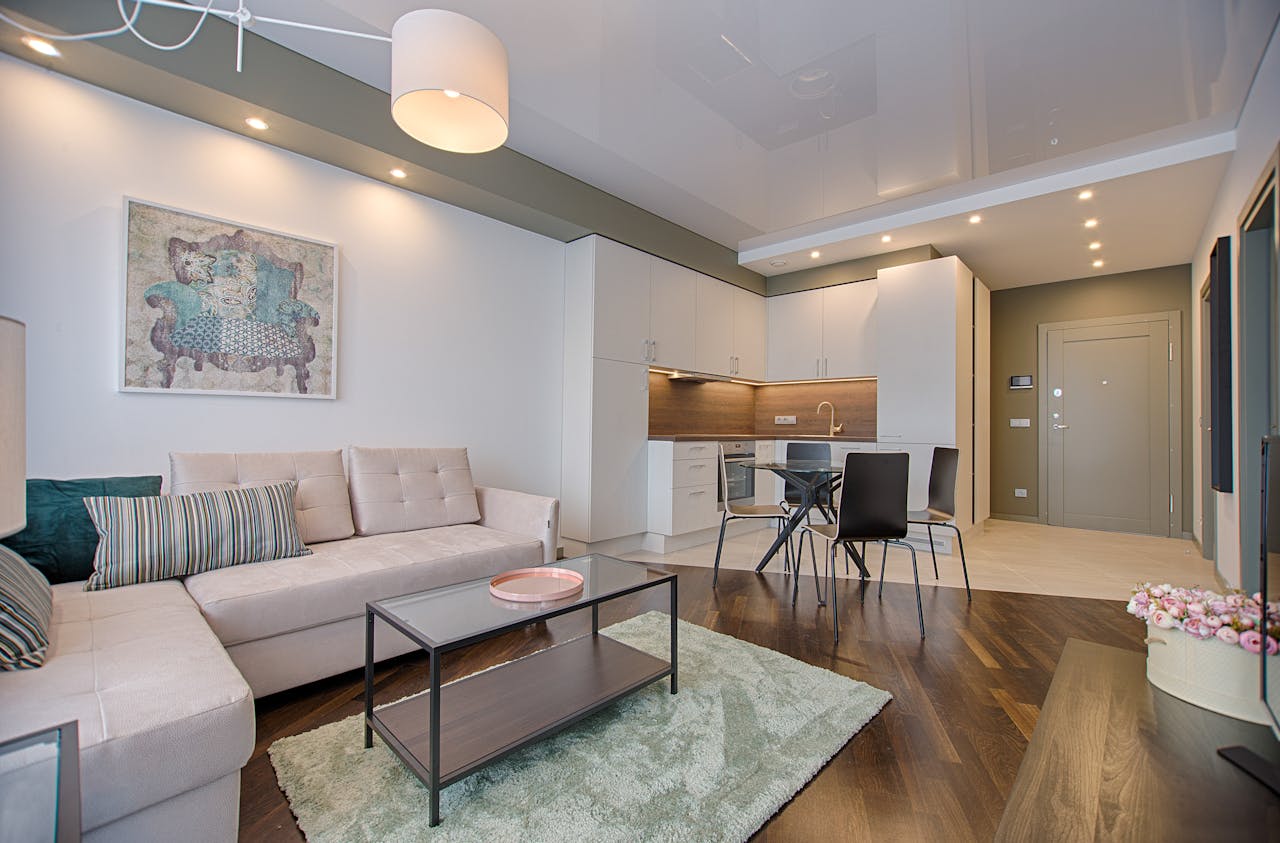 services-01 Spacious modern living room featuring chic furniture, stylish decor, and a minimalist kitchen.