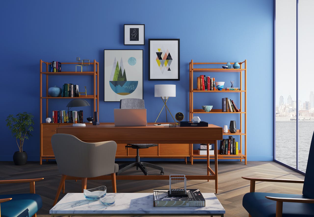 about-04 Elegantly decorated home office with modern furniture and a blue wall.
